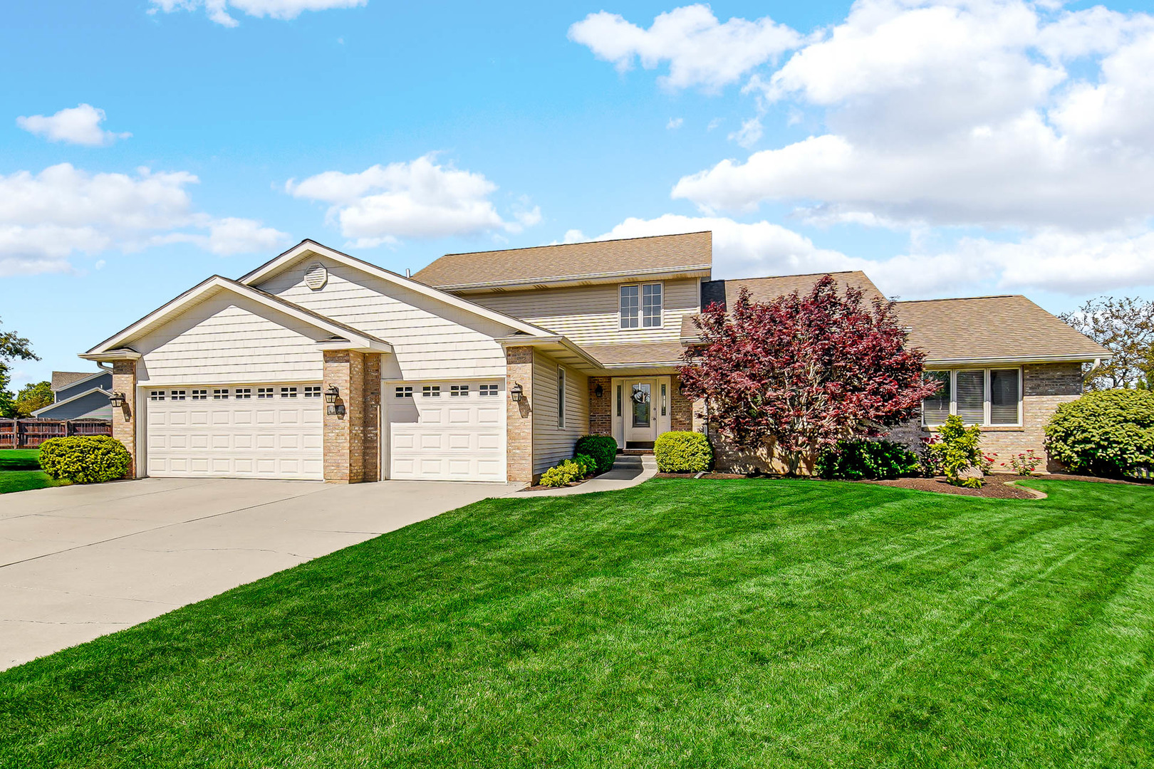 a view of a house with a yard and pathway