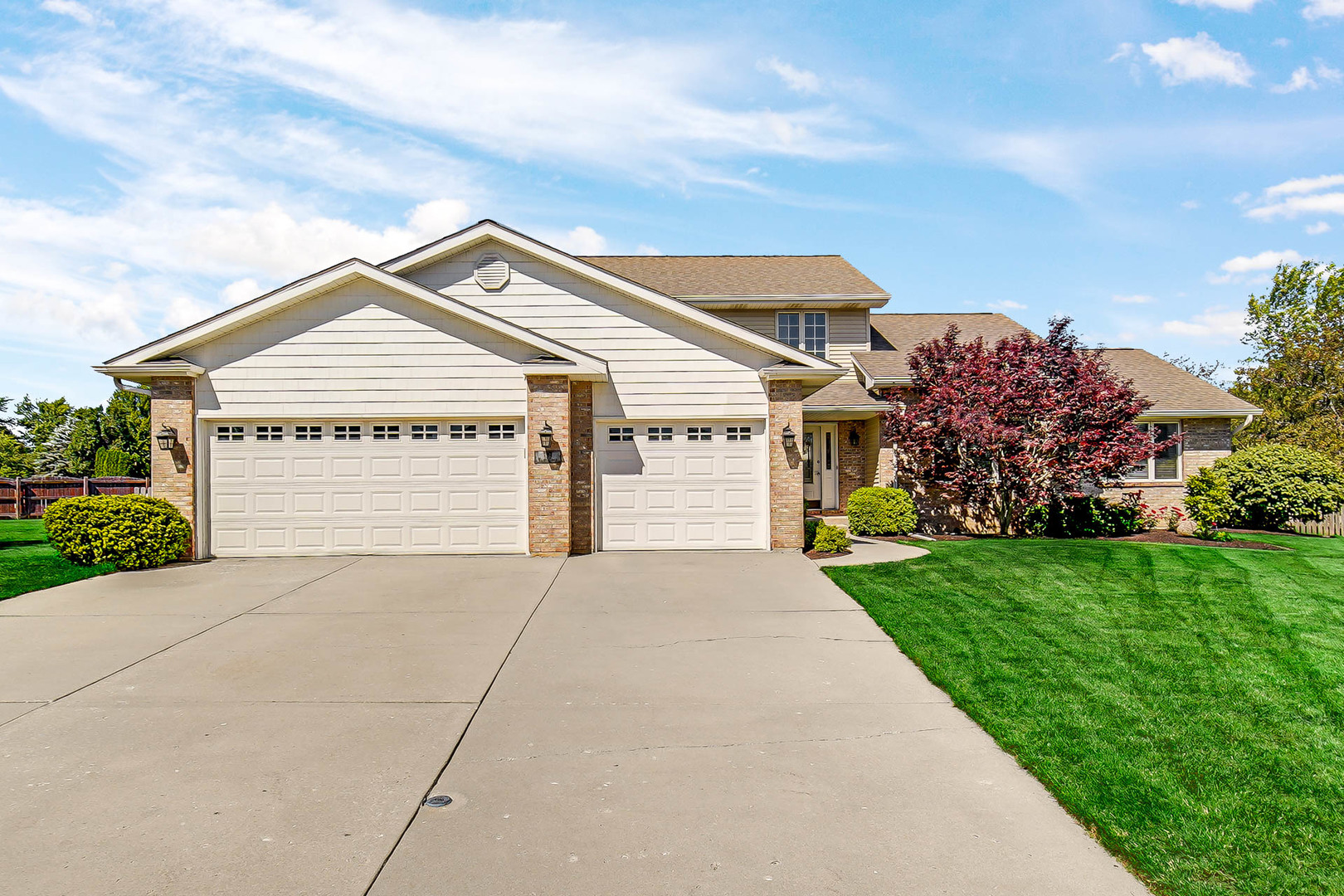 958 Willow Circle DeKalb, IL 60115 - Photo 2 of 35 a view of a house with a small yard and a large tree