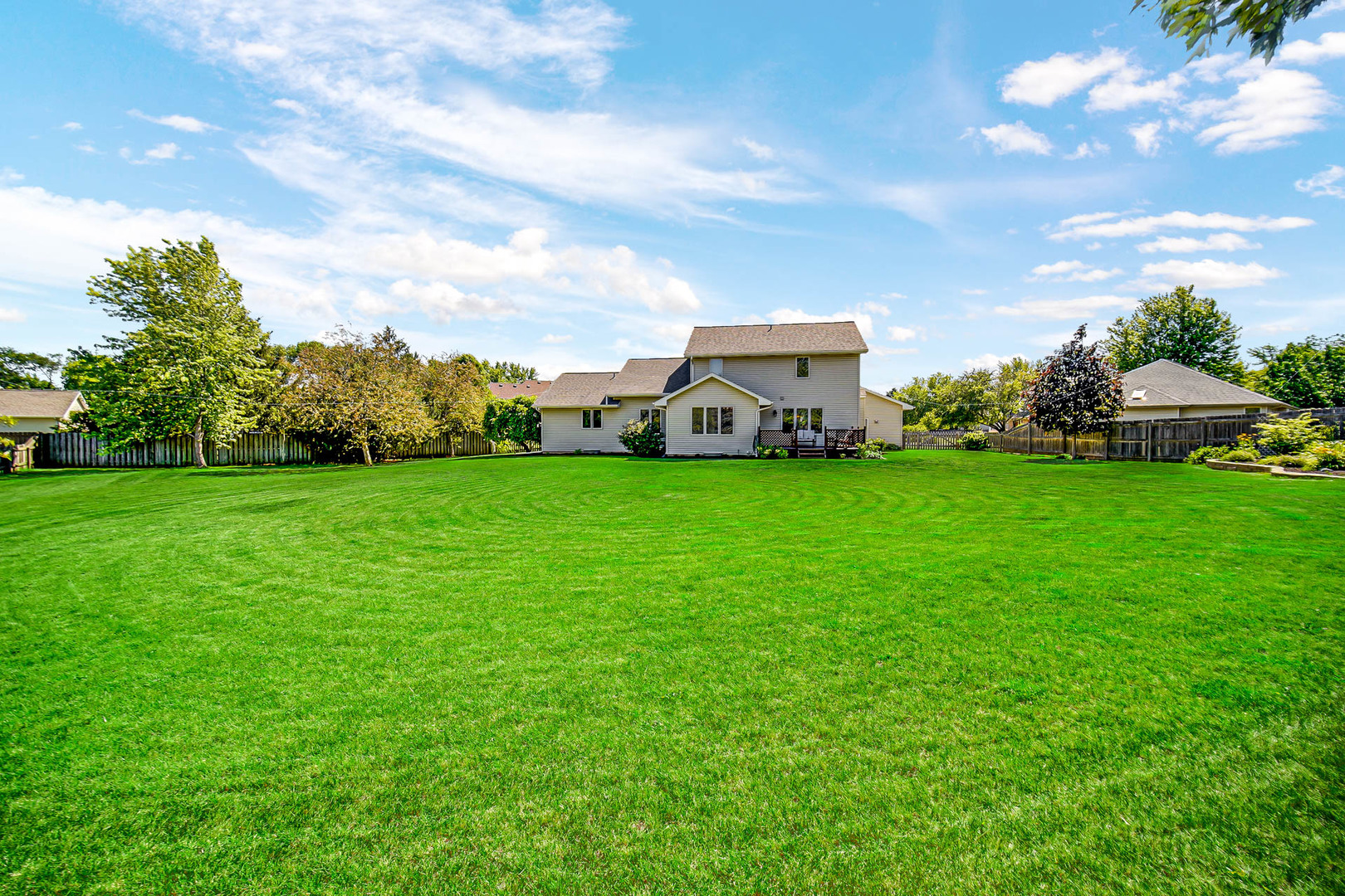 958 Willow Circle DeKalb, IL 60115 - Photo 6 of 35 a view of a house with a big yard and large trees
