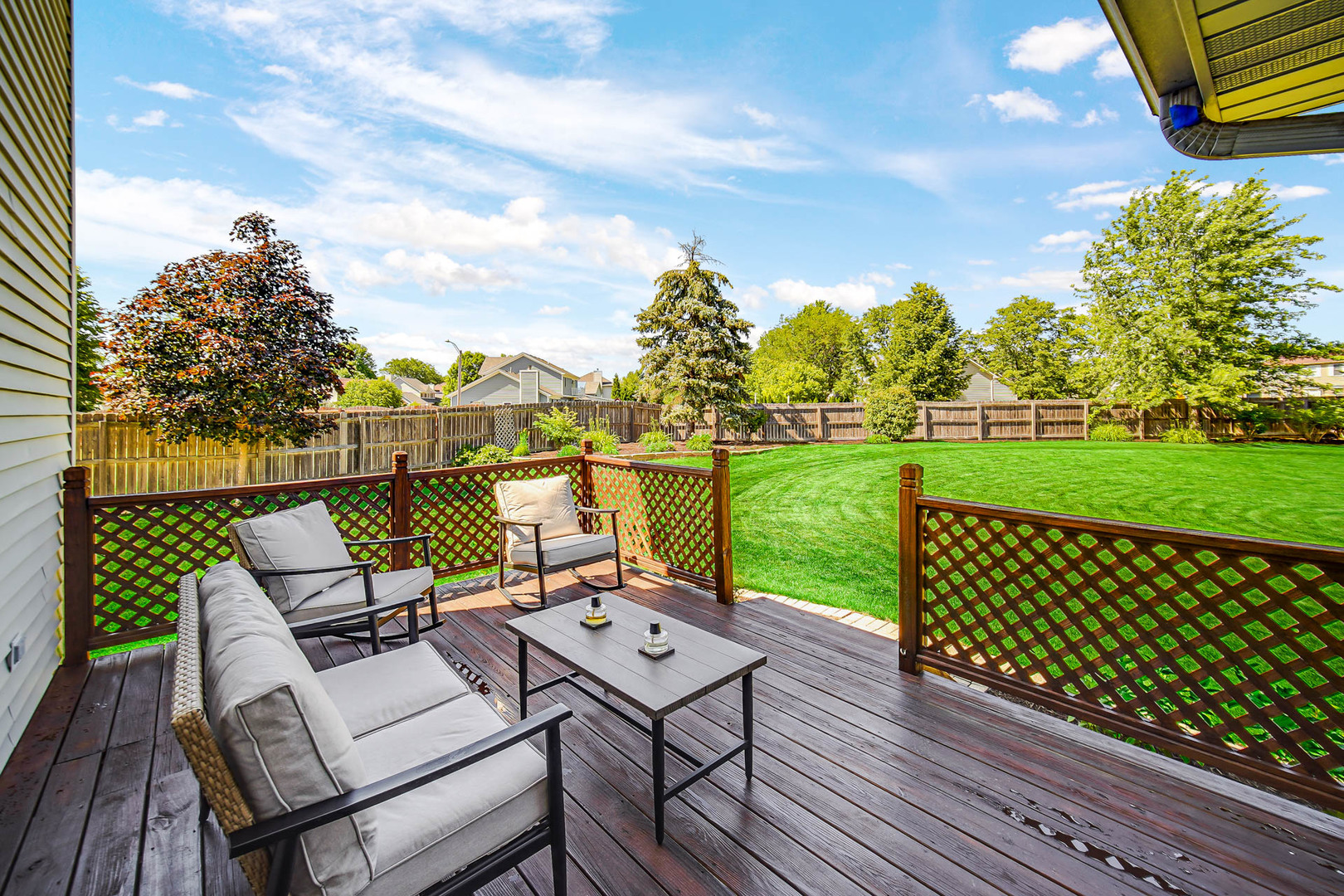 958 Willow Circle DeKalb, IL 60115 - Photo 9 of 35 a view of a patio with table and chairs with wooden floor and fence