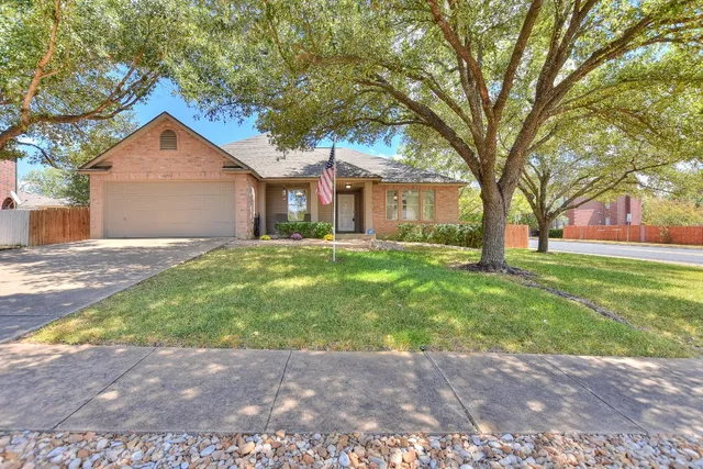 a house with huge green field in front of it