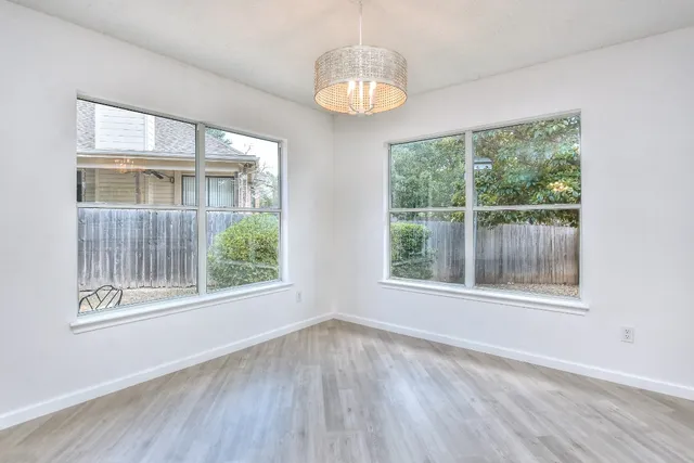 wooden floor in an empty room with a ceiling fan