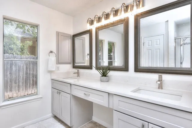 an empty room with wooden floor and a ceiling fan