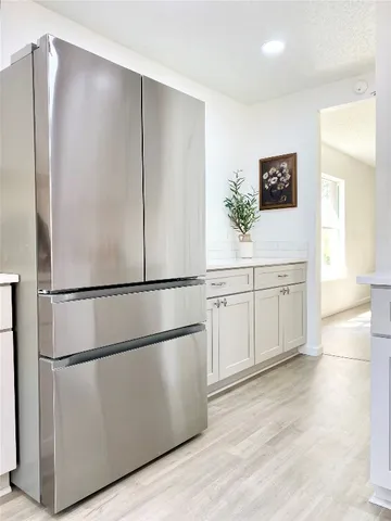 a white refrigerator freezer sitting inside of a kitchen