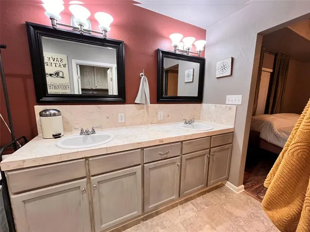 a bathroom with a double vanity sink and a mirror