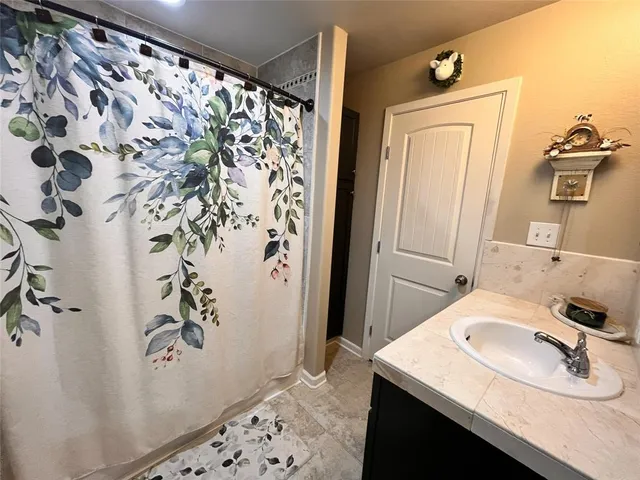a bathroom with a shower and a tub