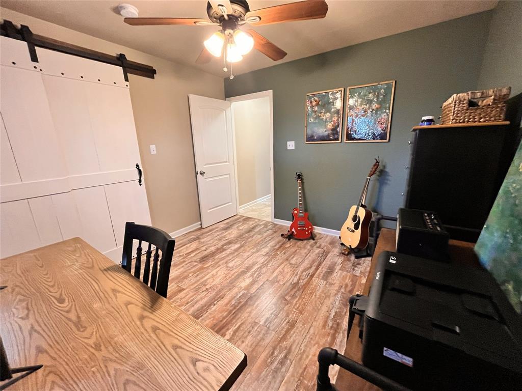 420 Sessums Road Springtown, TX 76082 - Photo 34 of 40 a bedroom with bed and wooden floor