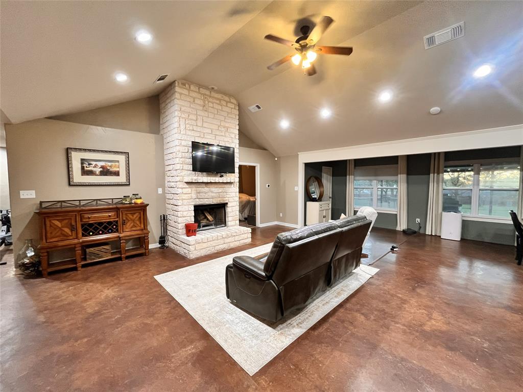 420 Sessums Road Springtown, TX 76082 - Photo 8 of 40 a living room with furniture a fireplace and a flat screen tv