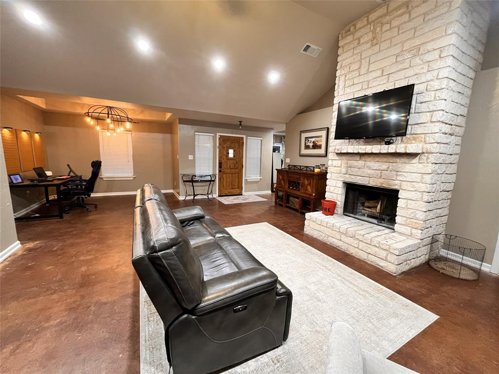 420 Sessums Road Springtown, TX 76082 - Photo 9 of 40 a living room with furniture a flat screen tv and a fireplace