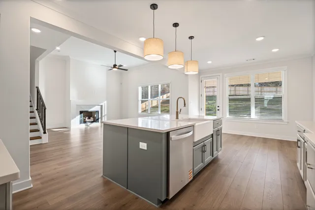 a kitchen with a stove and wooden floor