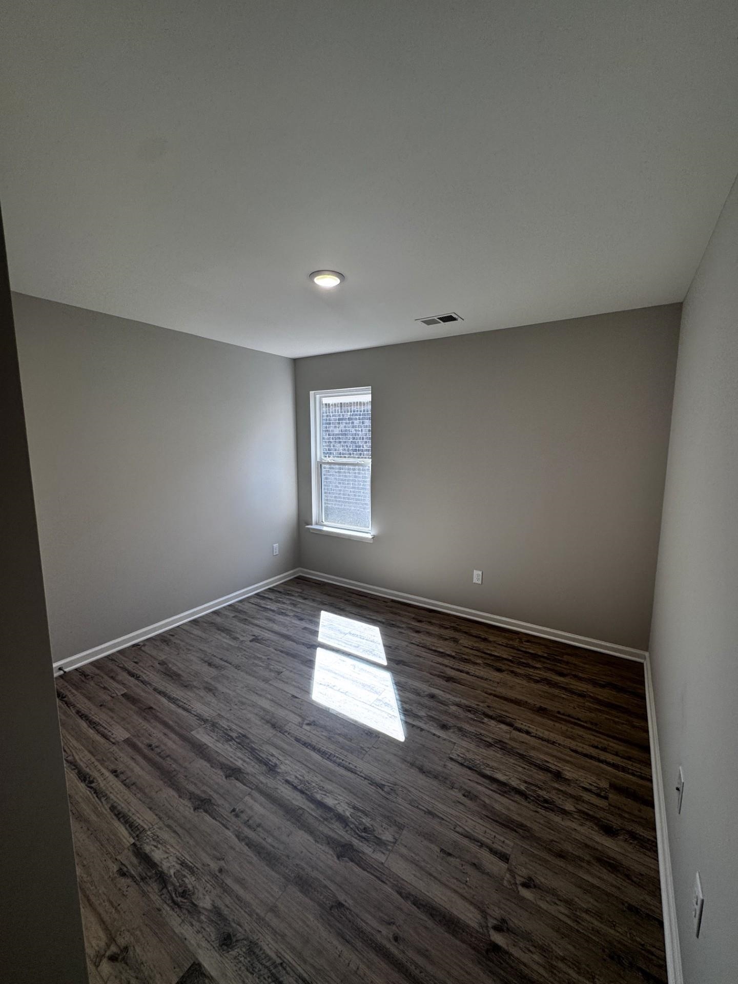 5249 Zodiac Road Memphis, TN 38118 - Photo 8 of 16 Unfurnished room featuring dark wood finished floors