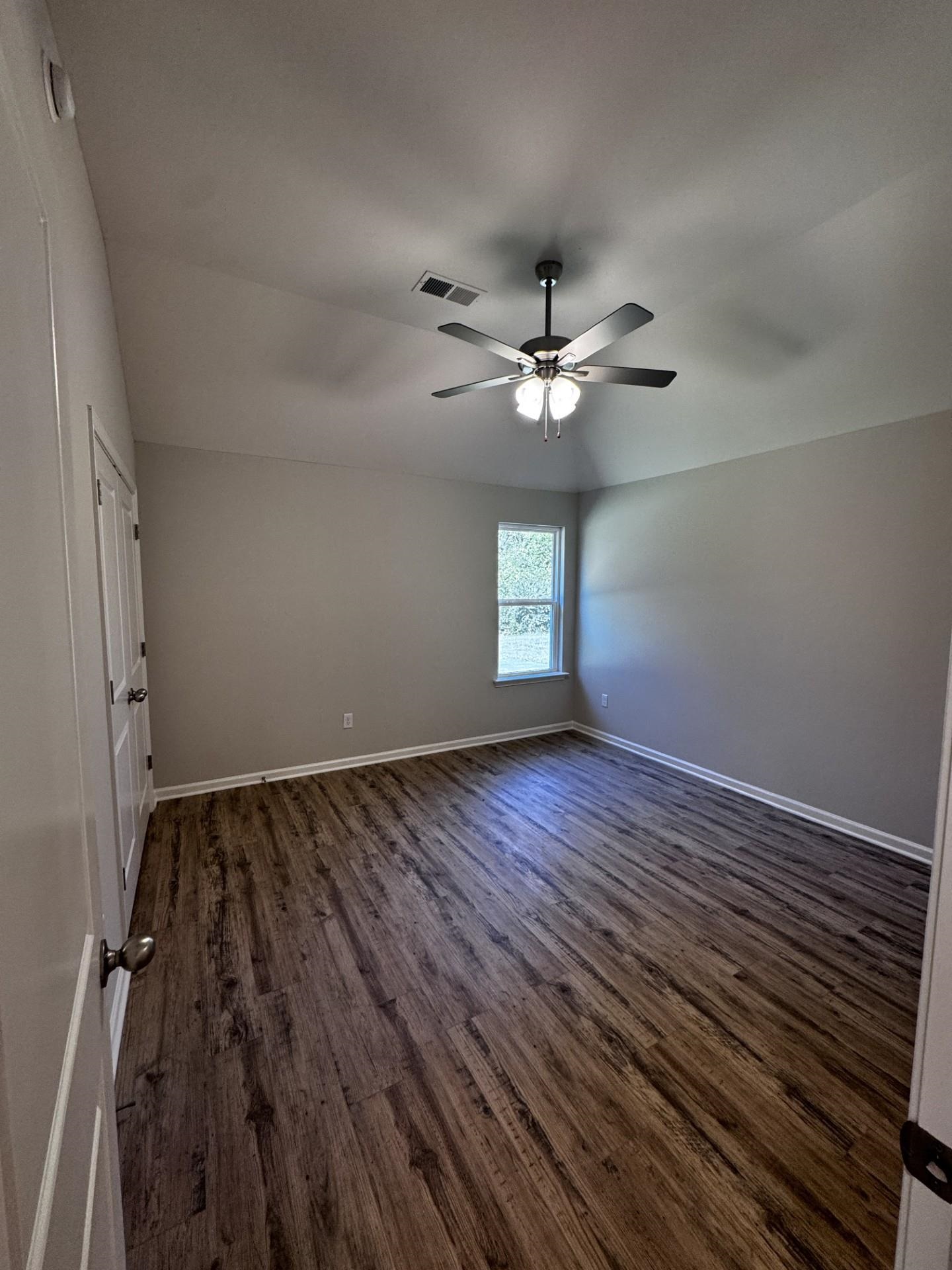 5249 Zodiac Road Memphis, TN 38118 - Photo 9 of 16 Empty room with dark wood finished floors and ceiling fan
