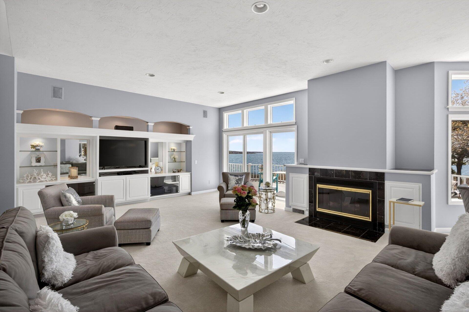 461 Wings Neck Road Pocasset, MA 02559 - Photo 11 of 42 a living room with furniture a flat screen tv and a fireplace