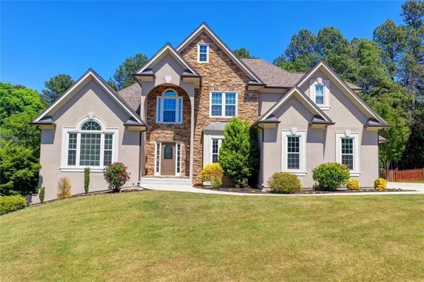 a front view of a house with a yard