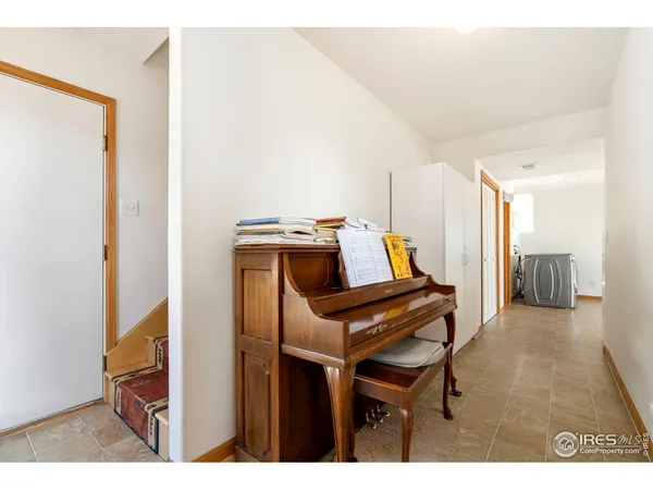 a view of an empty room with closet and a window