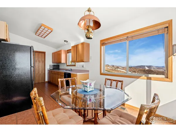a dining room with furniture a chandelier and window