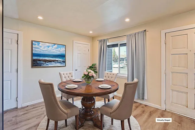 a view of a dining room with furniture window and wooden floor