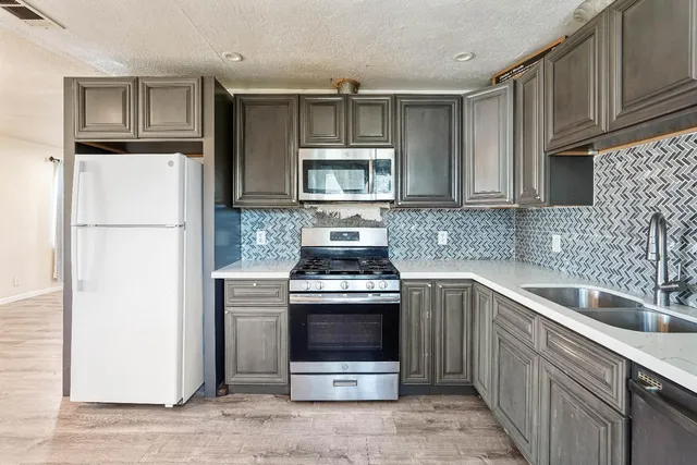 a kitchen with a stove sink and refrigerator