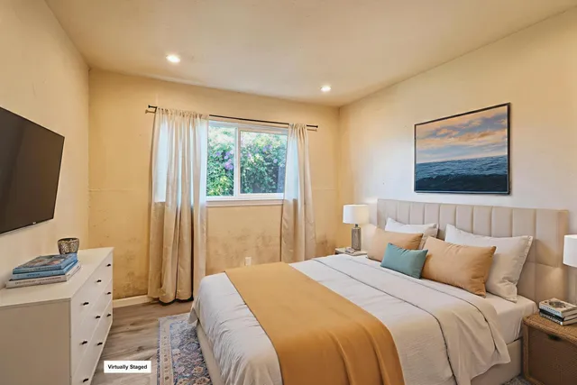 a bedroom with a bed and a flat screen tv