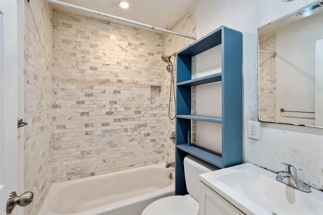 a bathroom with a bathtub and a sink