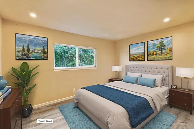 a bedroom with a bed and a painting on the wall