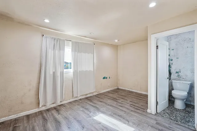 a view of an empty room and wooden floor