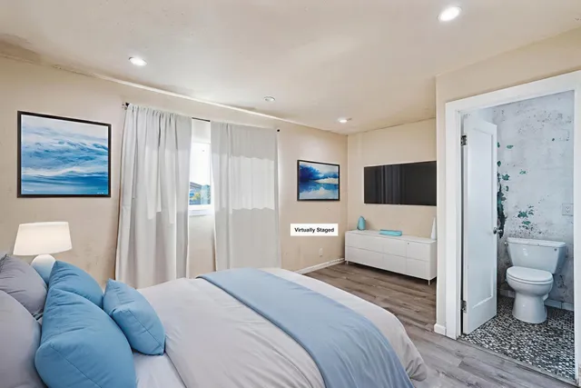 a bedroom with a bed and a view of bathroom