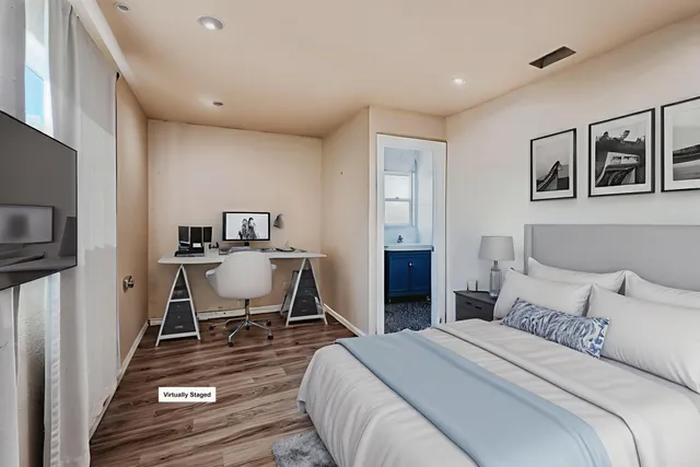 a bedroom with a bed and a tv on table