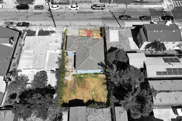 an aerial view of residential houses with outdoor space