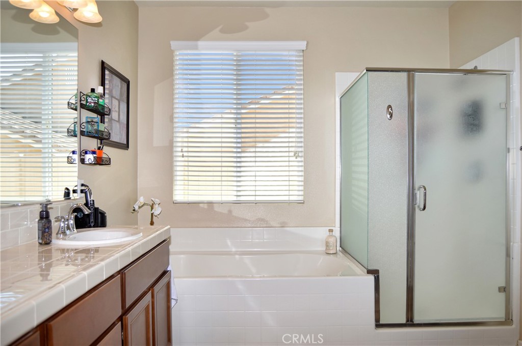 166 Fox Lane Calimesa, CA 92320 - Photo 38 of 76 Main Suite Bath with Dual Sinks, Soaking Tub, Glass-Enclosed Stall Shower, Private Toilet Room, and a Large Walk-in Closet