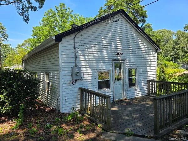 a front view of house with trees in the background