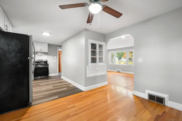 a view of a kitchen with furniture and a ceiling fan