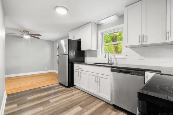 a kitchen with a refrigerator and a sink