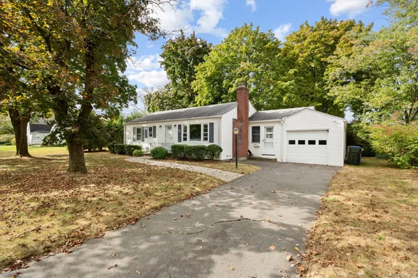 a view of house with outdoor space and trees
