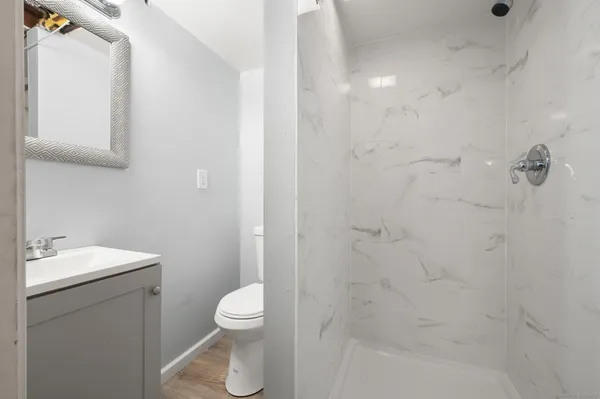 a bathroom with a toilet a sink and shower