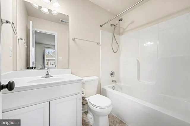 a bathroom with a sink toilet vanity and shower