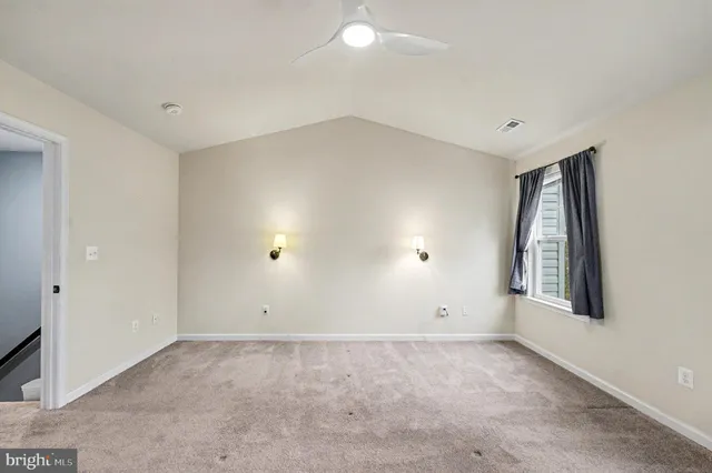 an empty room with closet and a fireplace