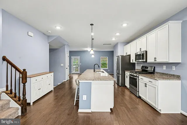 a kitchen with cabinets a sink and a stove