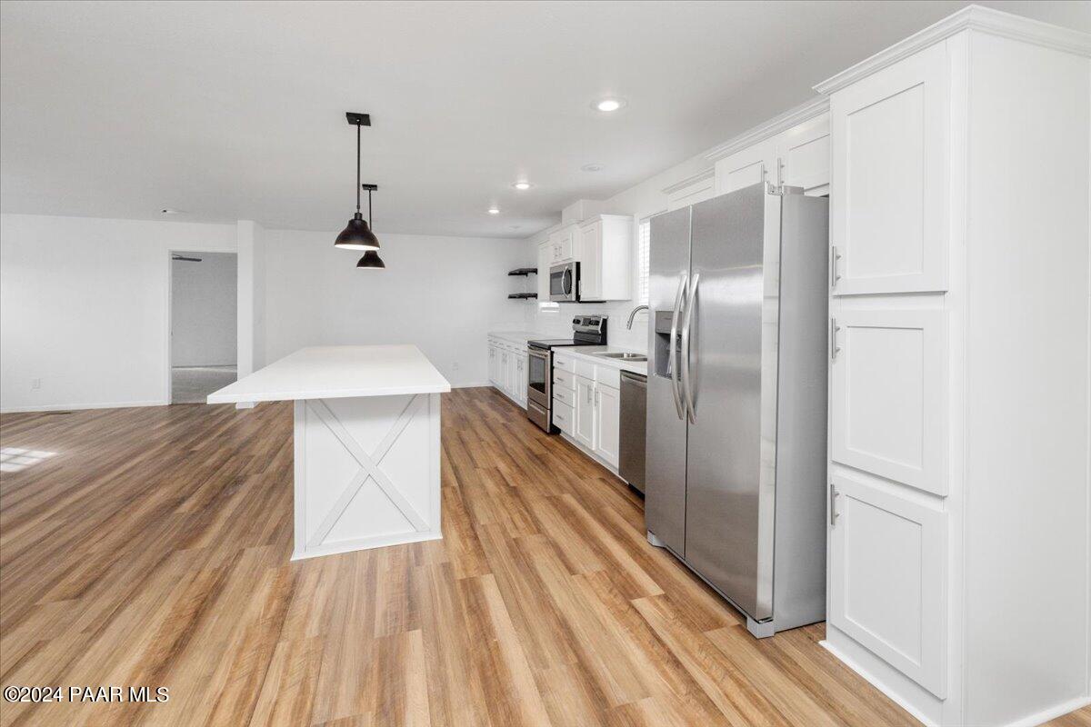 25341 North Mitchell Road Paulden, AZ 86334 - Photo 5 of 17 a kitchen with stainless steel appliances a refrigerator and a stove