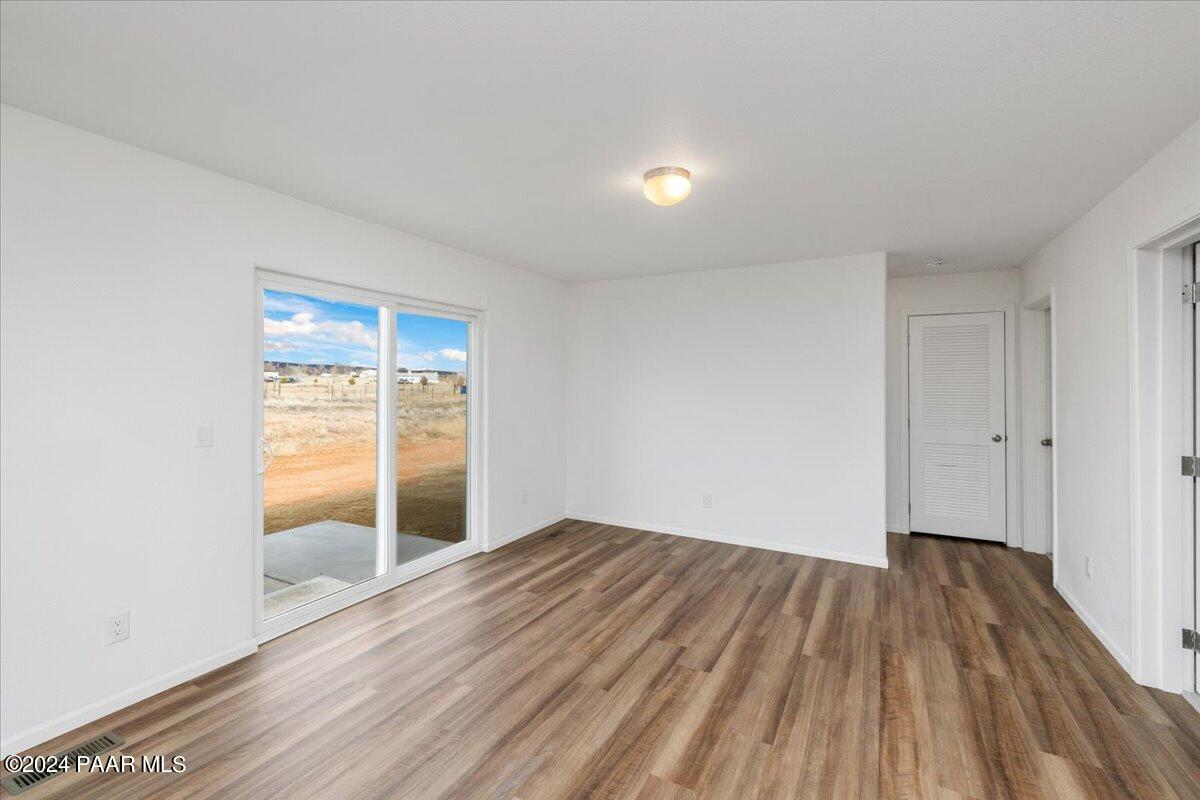 25341 North Mitchell Road Paulden, AZ 86334 - Photo 6 of 17 wooden floor in an empty room with a window
