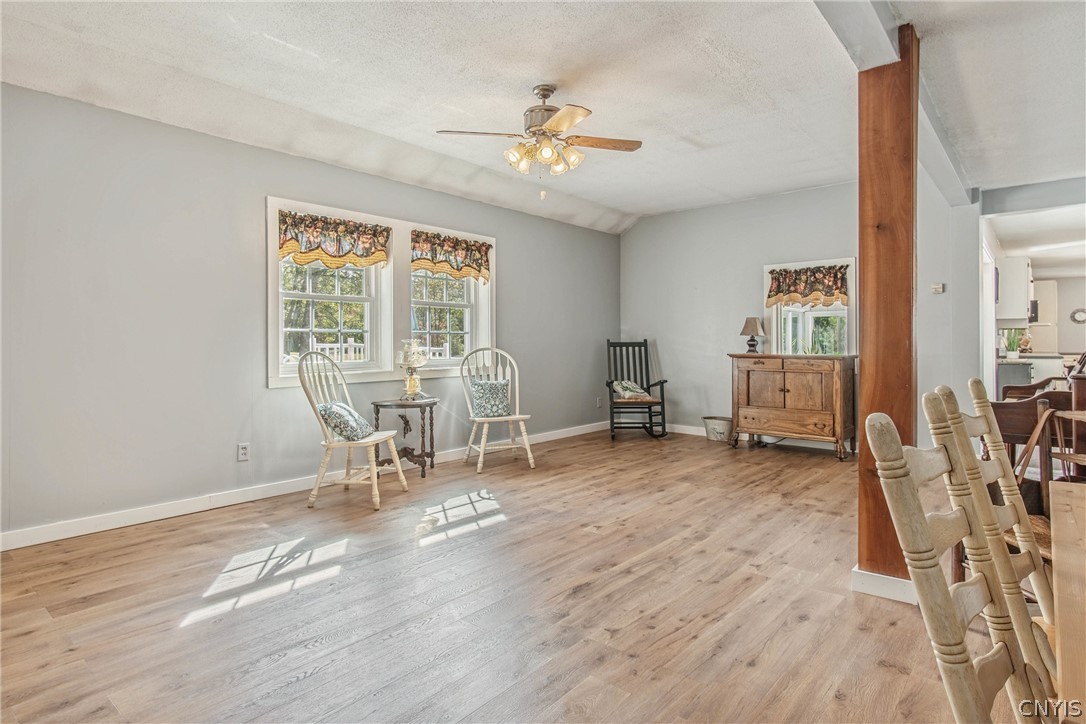 15384 Fuller Road Adams, NY 13606 - Photo 36 of 50 Warm wood flooring and classic sash windows define this inviting open living space.