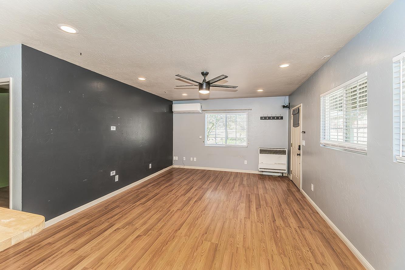 34664 Wilson Road Auberry, CA 93602 - Photo 11 of 35 a view of an empty room with a window and wooden floor
