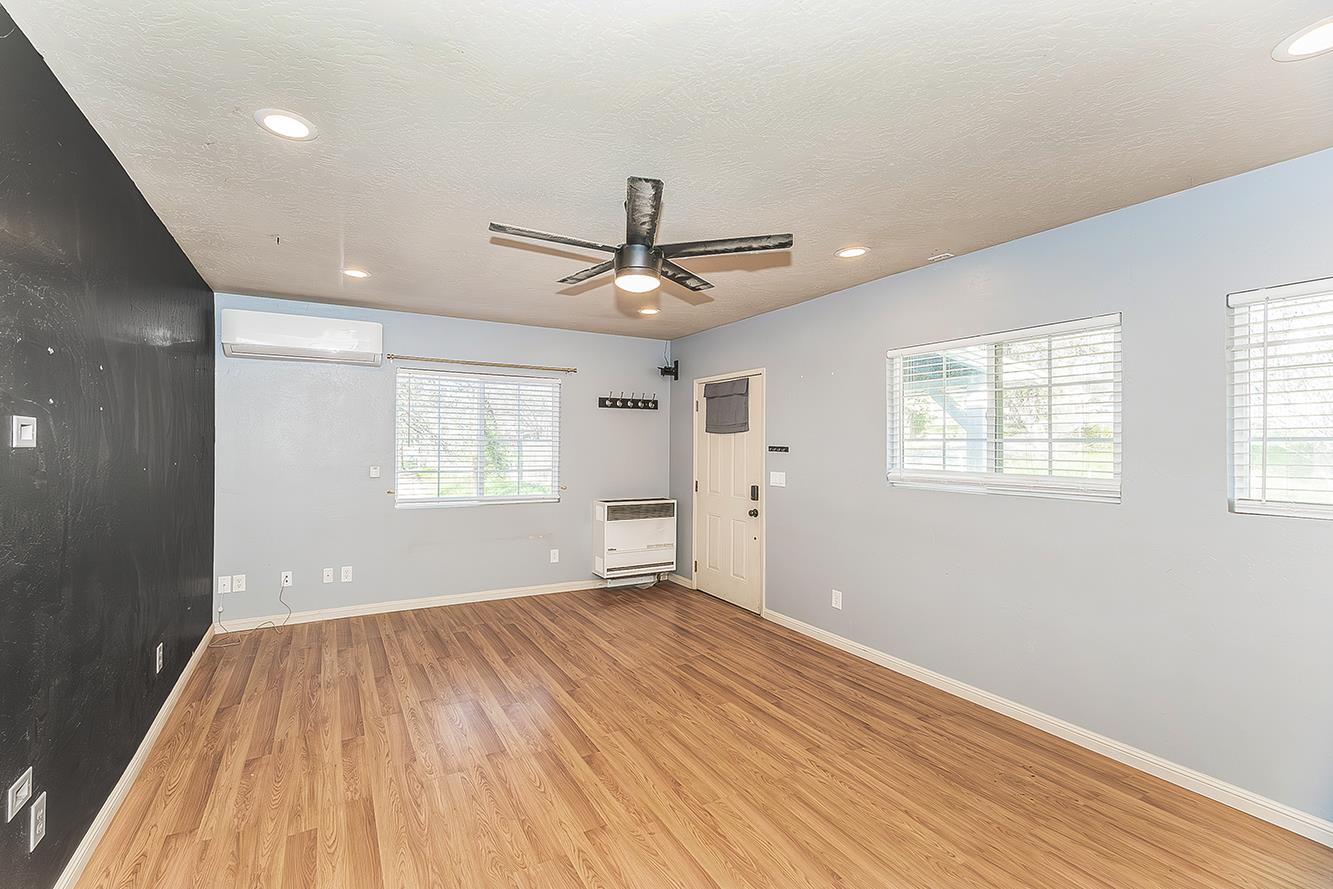 34664 Wilson Road Auberry, CA 93602 - Photo 12 of 35 a view of an empty room with wooden floor and a window