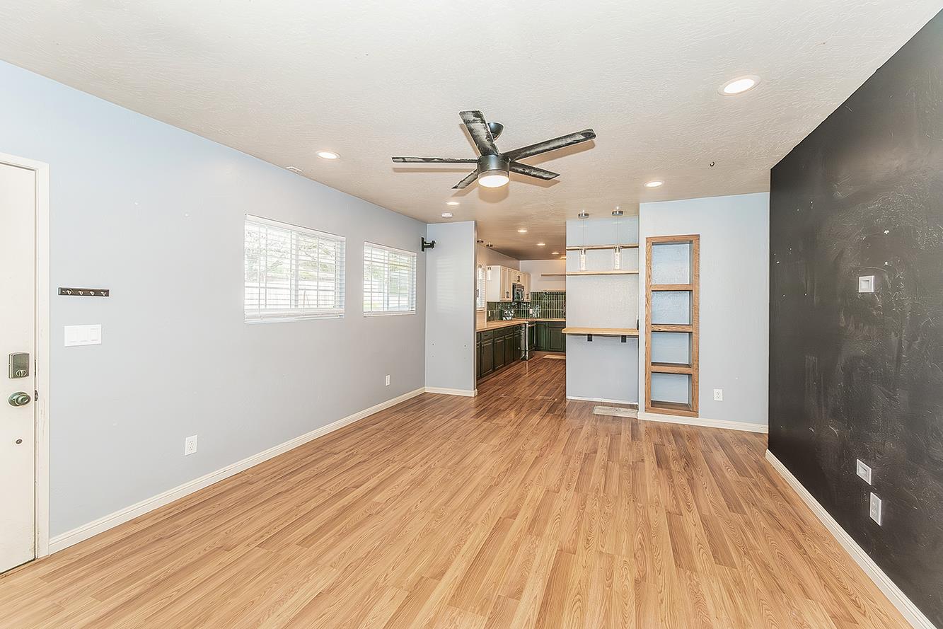 34664 Wilson Road Auberry, CA 93602 - Photo 13 of 35 a view of empty room with wooden floor and kitchen view