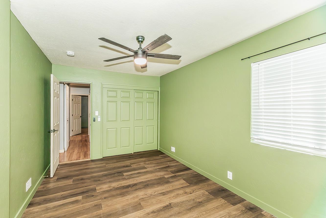 34664 Wilson Road Auberry, CA 93602 - Photo 17 of 35 a view of an empty room with wooden floor and a window
