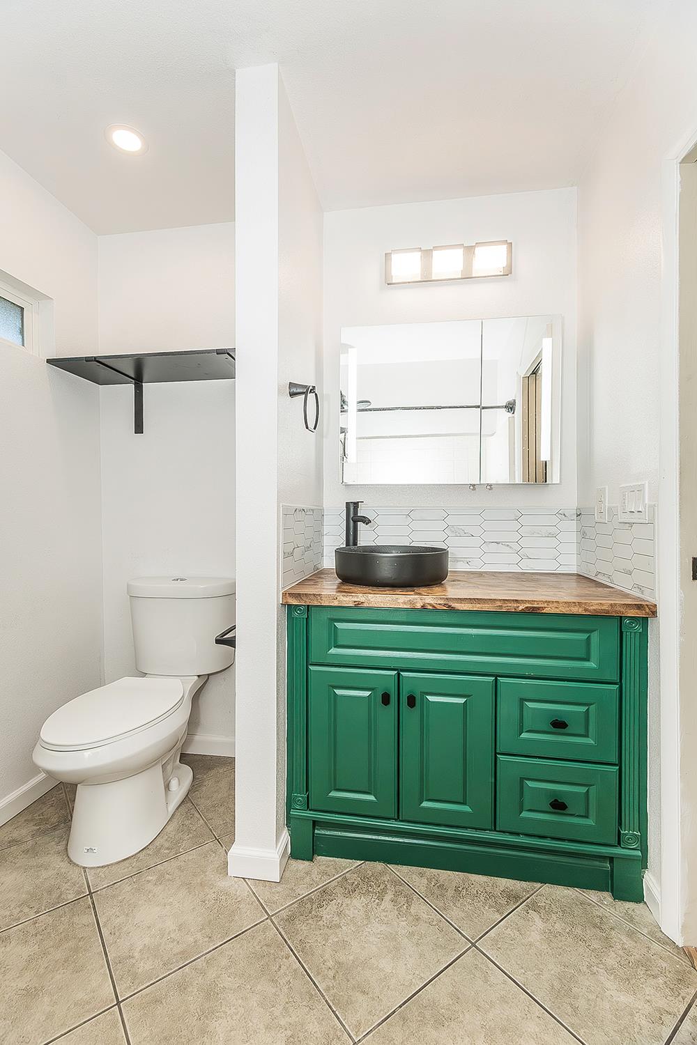 34664 Wilson Road Auberry, CA 93602 - Photo 19 of 35 a bathroom with a granite countertop toilet sink and mirror