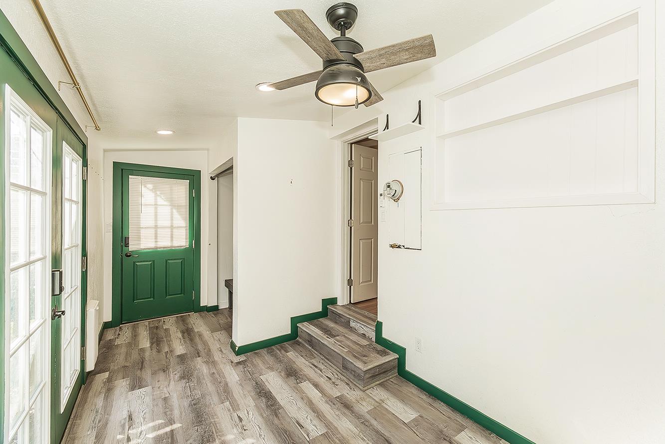 34664 Wilson Road Auberry, CA 93602 - Photo 26 of 35 a view of a hallway with wooden floor and a ceiling fan