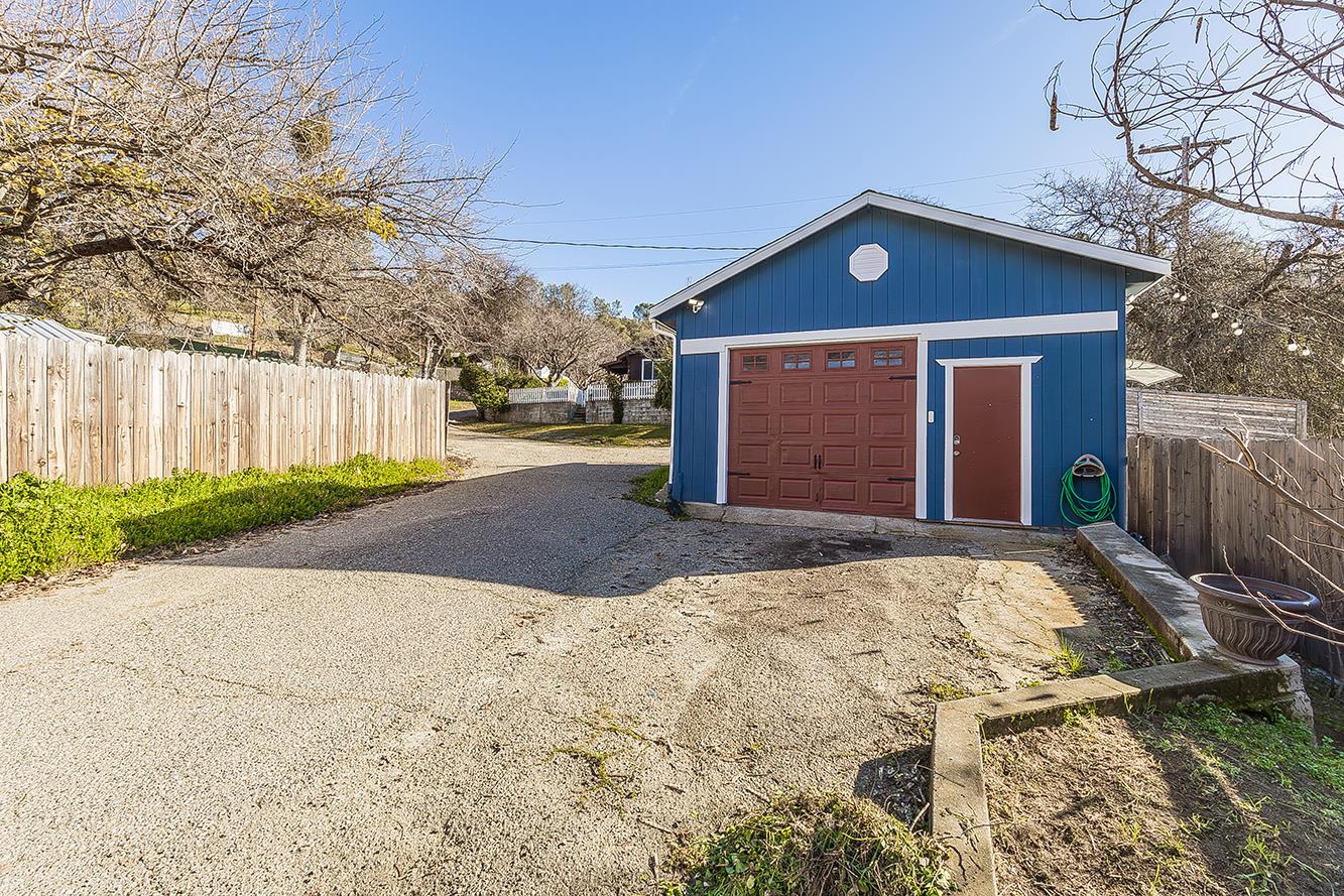 34664 Wilson Road Auberry, CA 93602 - Photo 31 of 35 a front view of house with yard and trees in the background