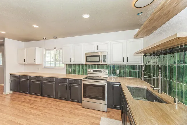 a kitchen with stainless steel appliances kitchen island granite countertop a sink and cabinets