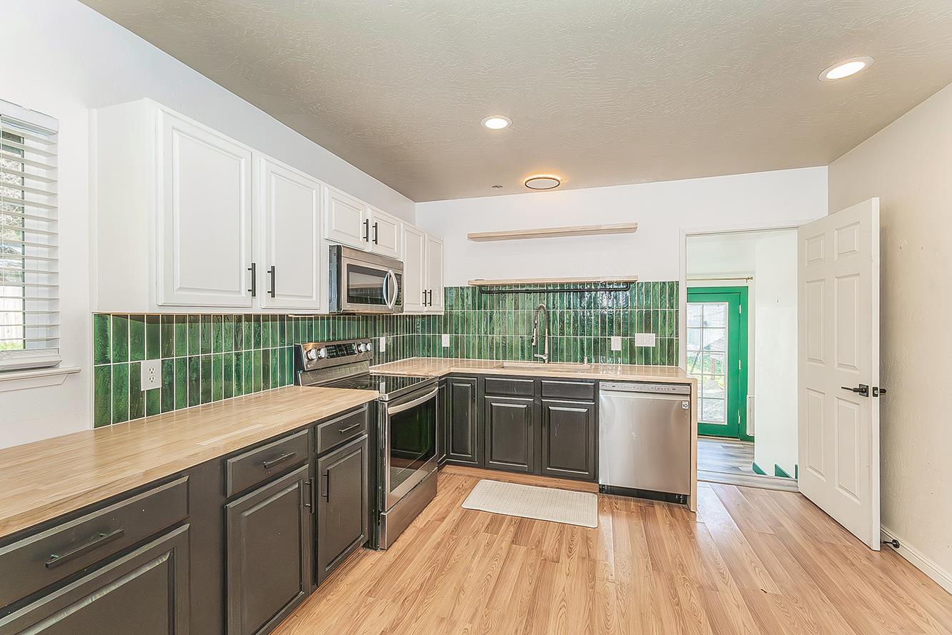 34664 Wilson Road Auberry, CA 93602 - Photo 9 of 35 a kitchen with stainless steel appliances granite countertop a stove sink and cabinets